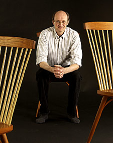 Photo of Chris with 3 chairs.